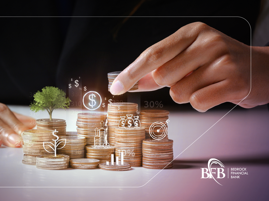 Hands growing savings with stacked coins